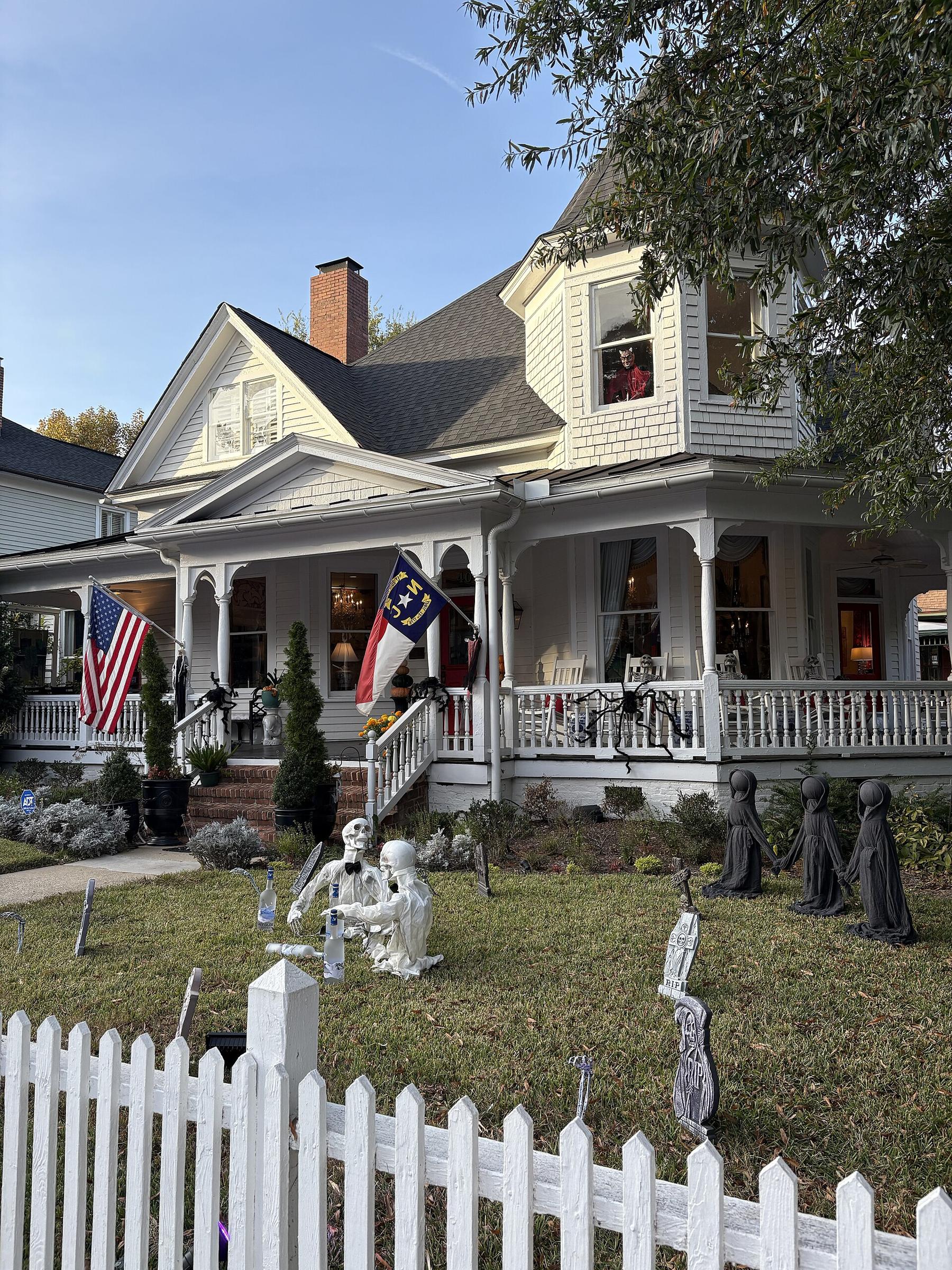Victorian home with a white picket fence in a historic Raleigh neighborhood